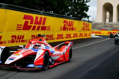 Formula E vehicle with DHL logo in the background.